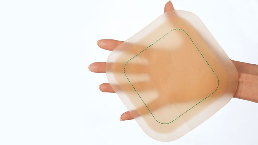 hand holding a wound dressing