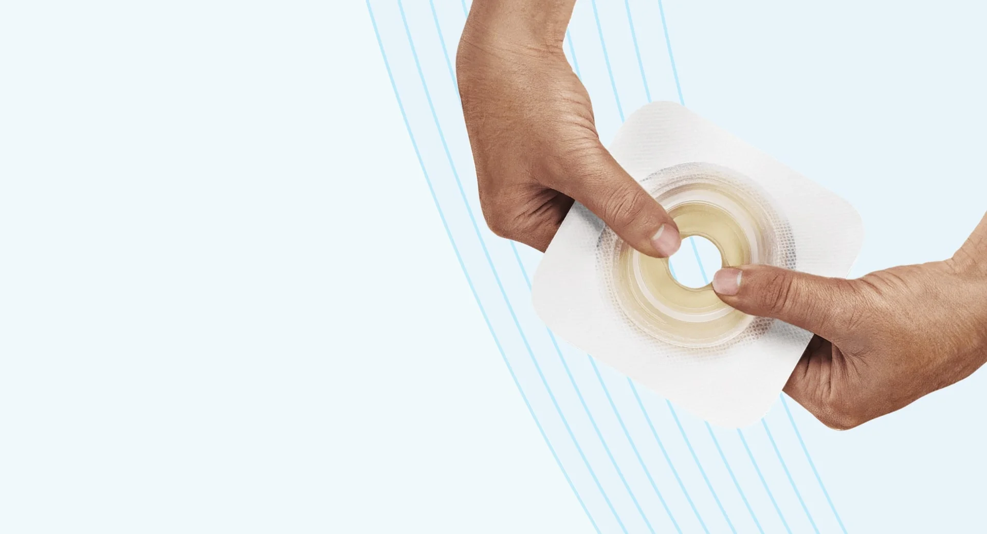 a close-up of hands holding a skin barrier