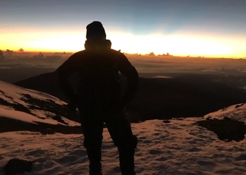 man living with a stoma posing outdoors during sunset 