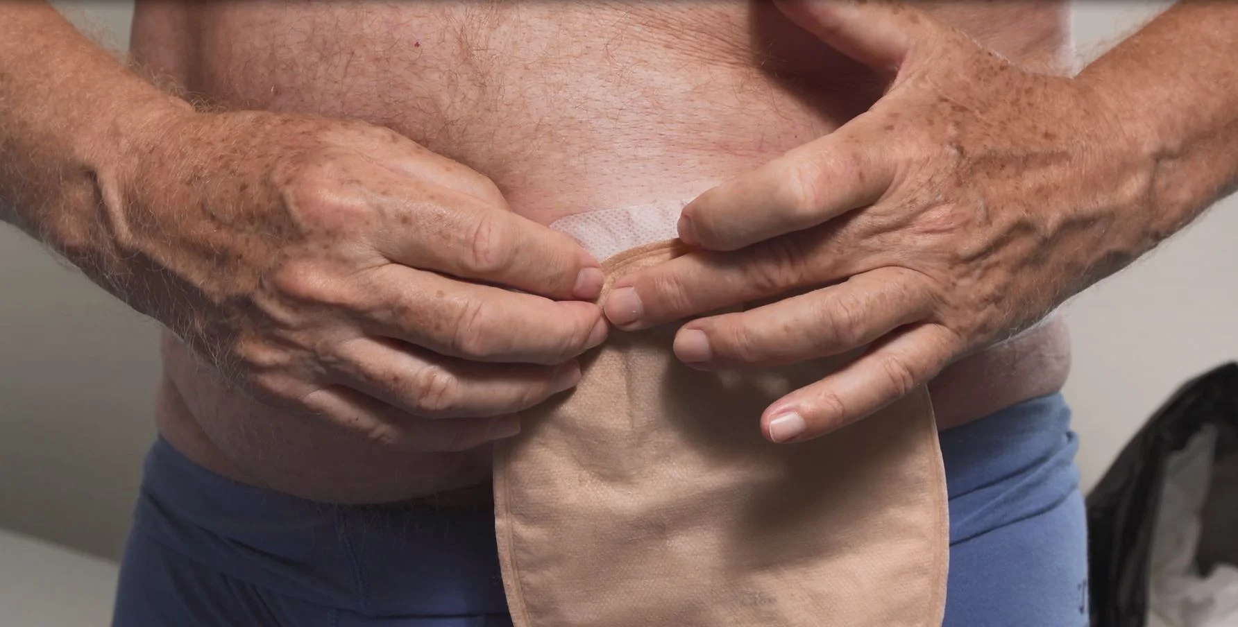 a close-up of a man holding his hands together