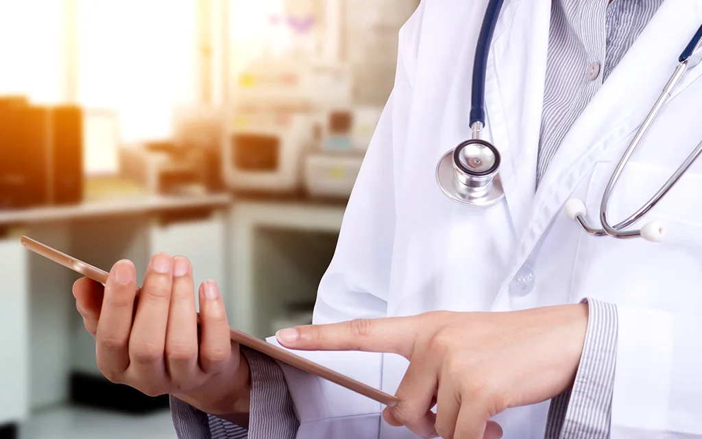 a doctor looking at a tablet